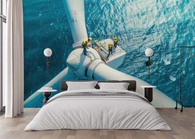 People works on top of wind turbine in sea, engineers perform maintenance of windmill in ocean, aerial view. Concept of energy, power, sustainable development Wall mural