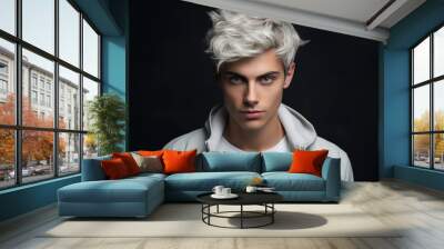 Young man with short blond hair on black studio background. Portrait of handsome boy model wearing white jacket. Concept of style, fashion, beauty, male face, stylish hairstyle Wall mural