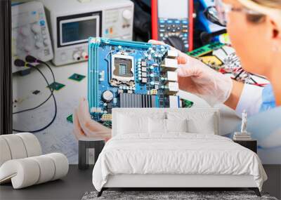 Female electronic engineer examining computer motherboard in laboratory Wall mural