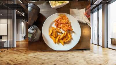 A plate of food with a camera on the table Wall mural