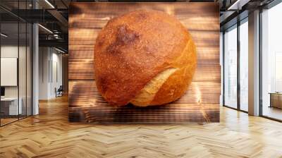 Fresh wheat bread on a wooden background Wall mural