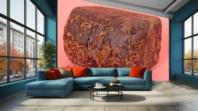 Rye bread sprinkled with cumin seeds on a pink background. Wall mural