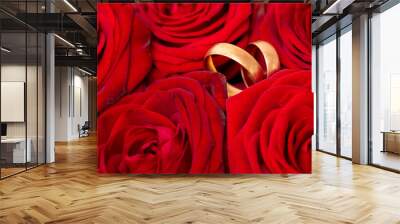 Two gold rings in the colors of red roses. Wall mural