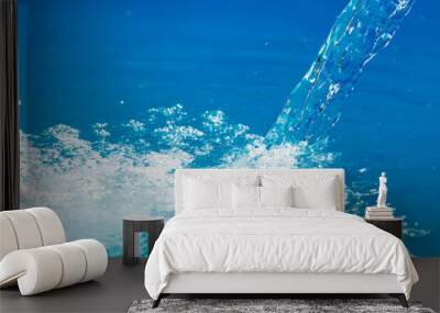 Water is poured into a pool Wall mural