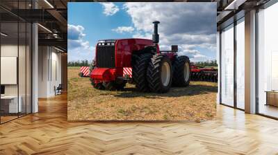 Autonomous unmanned tractor with plow working on the field. Smart farming Wall mural