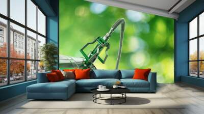 Biofuel filling nozzle with storage tank on a green background Wall mural