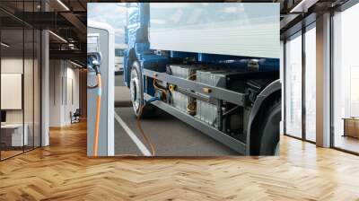 Electric truck batteries are charged from the charging station. Concept Wall mural