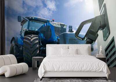 Electric vehicles charging station on a background of agricultural tractor. Concept Wall mural