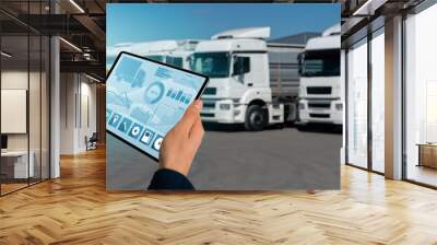 Manager with a digital tablet on the background of trucks. Fleet management	 Wall mural