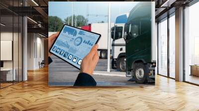 Manager with a digital tablet on the background of trucks. Fleet management Wall mural