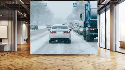 Traffic jam on city street in snowfall Wall mural