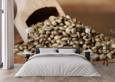 Closeup of hemp seed in a bowl with a scoop.Dried hemp seed in a wooden bowl on wooden background. Wall mural