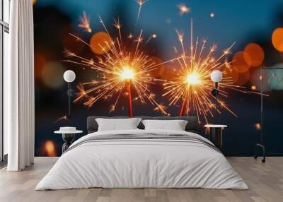 A close-up image of two sparklers burning brightly against a blurred background with warm lights, symbolizing celebration and festive atmosphere. Ideal for holiday or party-themed designs.

 Wall mural