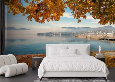 Scenic view of the Traunsee in Gmunden, OÖ, Austria, on a beautiful day in autumn with an orange colored tree in the foreground Wall mural