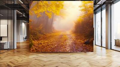 A misty morning in the forest with vibrant yellow and orange leaves lining the trail. Wall mural