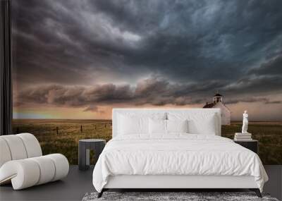 A severe thunderstorm approaches an old abandoned church in the countryside during the late afternoon in Colorado.  Wall mural