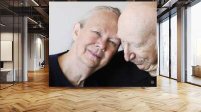 Close-up of senior couple embracing focuses on smiling woman Wall mural