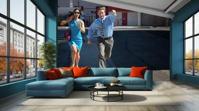 Handsome man and pretty woman are late. Wall mural