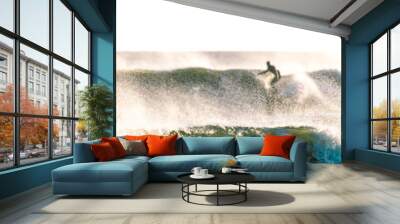 Large waves with a surfer in the background.  Selective focus - blurry background.  Wall mural