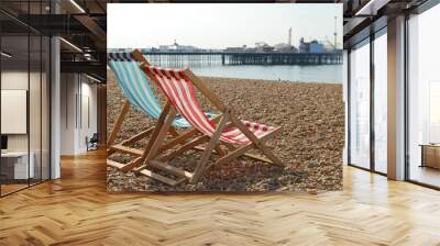 deckchairs on brighton beach and pier, england Wall mural