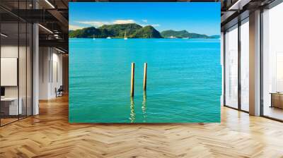 
A beautiful view of Langkawi island against a beautiful blue sky with  some boats in the distance on the horizon. Tropical scenery. located at Kedah, Malaysia - September  25  2024: Wall mural