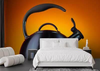 Close-up photo of stainless steel kettle in neon light over orange background. Wall mural