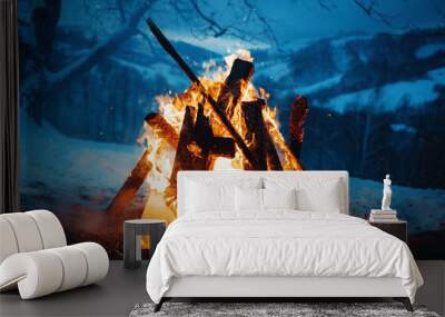 Winter campfire in the top of the mountains at the evening. Wall mural