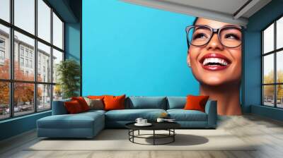 Smiling Woman with Glasses on Blue Background. Generative ai Wall mural