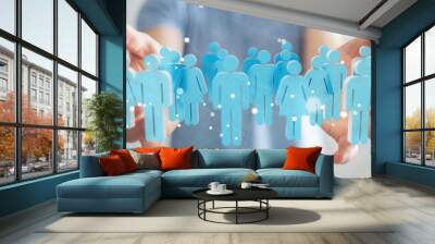 Businessman holding 3D rendering group of people in his hand Wall mural