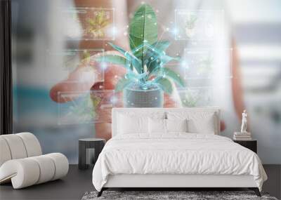 Man holding and touching holographic projection of a plant with digital analysis 3D rendering Wall mural