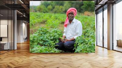 Indian happy farmer holding mobile in hand Wall mural