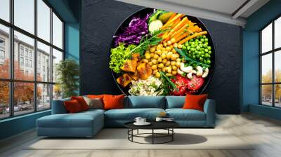 Bowl dish with brown rice, cucumber, tomato, green peas, red cabbage, chickpea, fresh lettuce salad and cashew nuts. Healthy balanced eating Wall mural