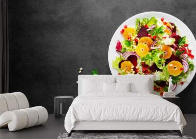 Christmas salad with boiled beet, red onion, tangerines, pomegranate, parsley, pine nuts and lettuce leaves Wall mural