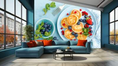 Cottage cheese pancakes, syrniki with fresh berries for breakfast Wall mural