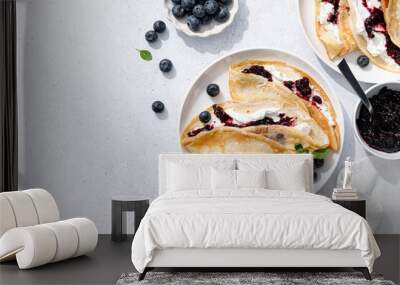 Crepes with blueberry jam, ricotta cheese and fresh berries. Pancakes for breakfast. Top view Wall mural