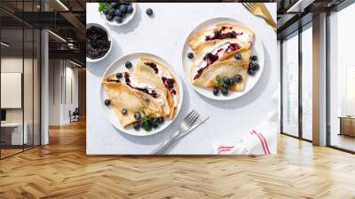 Crepes with blueberry jam, ricotta cheese and fresh berries. Pancakes for breakfast. Top view Wall mural