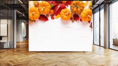 Festive autumn pumpkins decor with fall leaves, berries, nuts on white background. Thanksgiving day or halloween holiday, harvest concept. Top view flat lay composition with copy space for greeting Wall mural