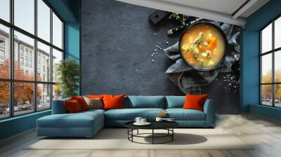 Fresh fish soup in bowl on dark background, top view Wall mural