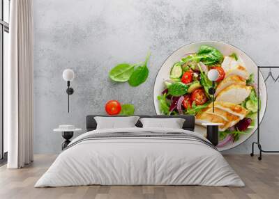 Grilled chicken breast, fillet and fresh vegetable salad of lettuce, arugula, spinach, cucumber and tomato. Healthy lunch menu. Diet food. Top view Wall mural