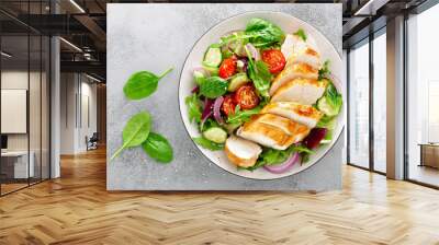 Grilled chicken breast, fillet and fresh vegetable salad of lettuce, arugula, spinach, cucumber and tomato. Healthy lunch menu. Diet food. Top view Wall mural