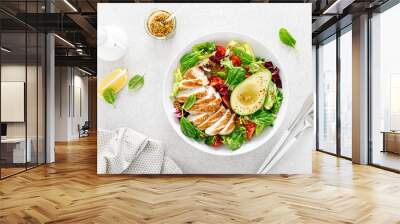 Grilled chicken meat and fresh vegetable salad of tomato, avocado, lettuce and spinach. Healthy and detox food concept. Ketogenic diet. Buddha bowl dish on white background, top view Wall mural