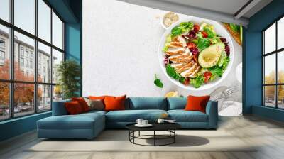 Grilled chicken meat and fresh vegetable salad of tomato, avocado, lettuce and spinach. Healthy and detox food concept. Ketogenic diet. Buddha bowl dish on white background, top view Wall mural