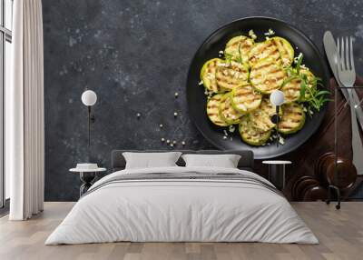 Grilled zucchini, courgette with garlic and rosemary on plate, top view Wall mural