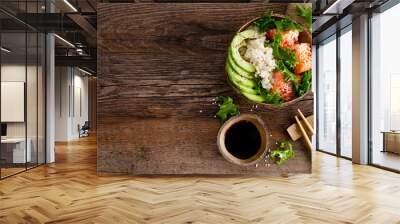 Hawaiian poke coconut bowl with grilled salmon fish, rice and avocado. Healthy food. Top view Wall mural