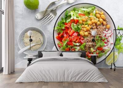 Healthy and delicious bowl with buckwheat and salad of chickpea, fresh pepper and lettuce leaves. Dietary balanced plant-based food. Vegan and vegetarian dish. Top view. Flat lay Wall mural