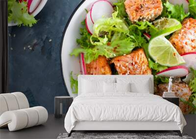 Healthy lunch salad with baked salmon fish, fresh radish, lettuce and lime. Top view Wall mural