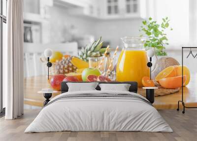 Multifruit juice and fresh fruit on table on kitchen background closeup Wall mural