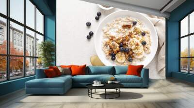 Oatmeal bowl. Oat porridge with banana, blueberry, walnut, chia seeds and almond milk for healthy breakfast or lunch. Healthy food, diet. Top view. Wall mural