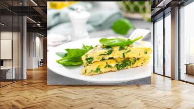 Omelet with spinach leaves. Omelette on plate, scrambled eggs Wall mural