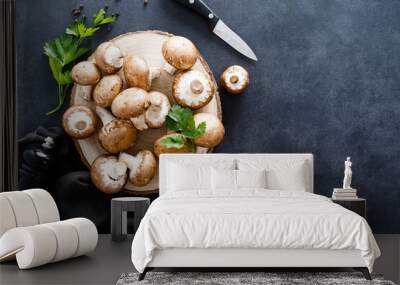 Raw mushrooms champignons on black background, cooking fresh champignons. Wall mural